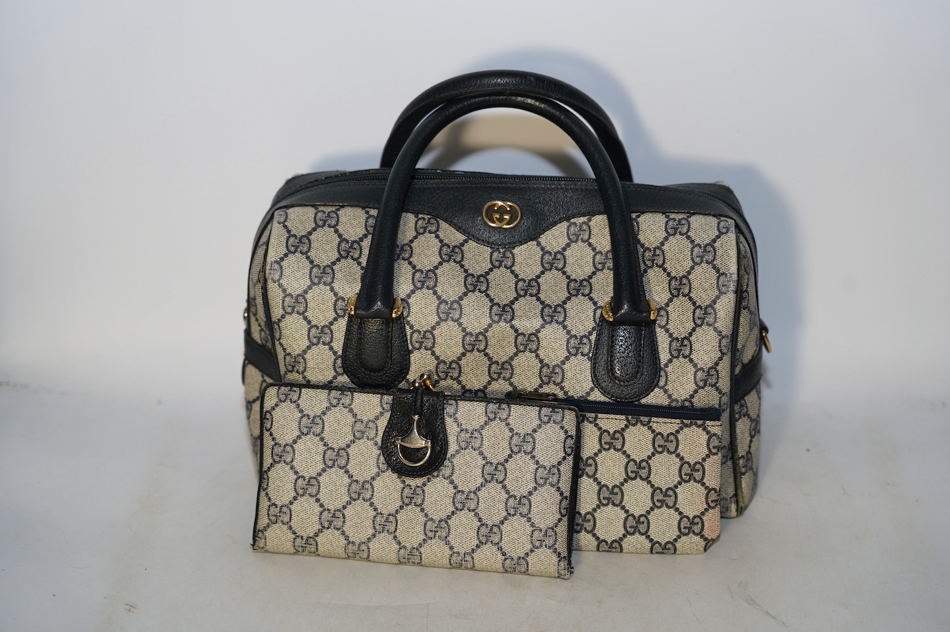 A Gucci monogram blue canvas handbag, wallet and purse